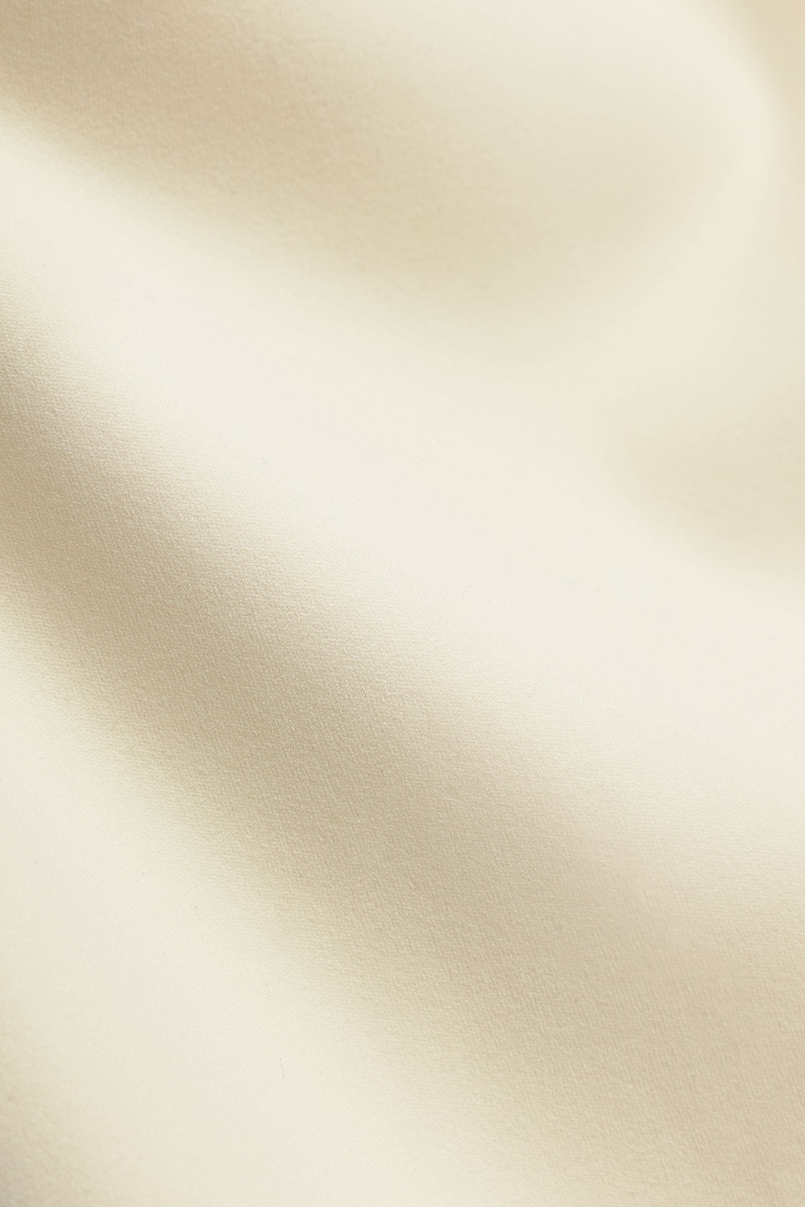 Close-up texture of butter yellow CASPARA Cloudform yoga pant fabric.